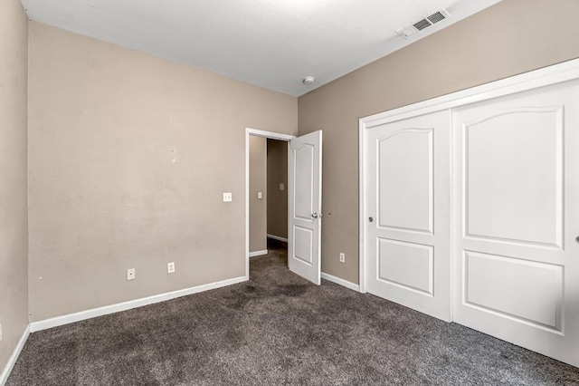3615 W Michigan Ave, Fresno, CA 93722 - unfurnished bedroom with dark carpet and a closet
