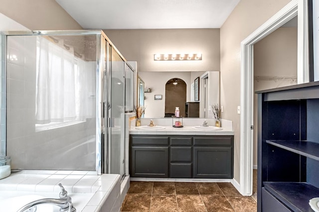 3615 W Michigan Ave, Fresno, CA 93722 - bathroom featuring a shower stall, double vanity, and a garden tub
