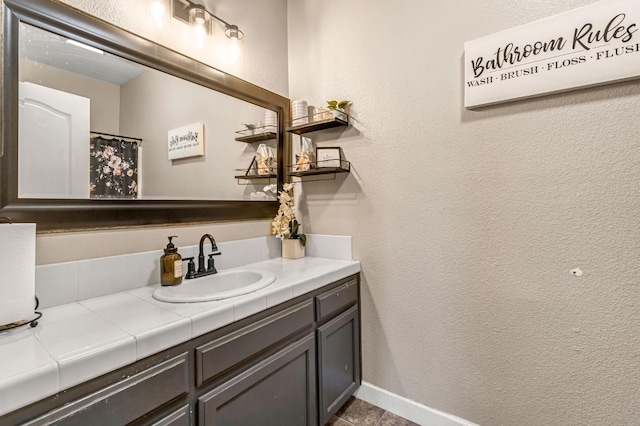 3615 W Michigan Ave, Fresno, CA 93722 - full bath with vanity, a textured wall, and tile patterned floors