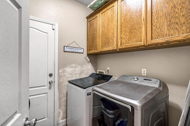 3615 W Michigan Ave, Fresno, CA 93722 - laundry area featuring cabinet space, washer and clothes dryer, and a textured wall