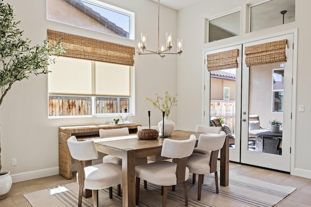 998 Highland Rd W, Madera, CA 93636 - dining space with a chandelier, light tile patterned flooring, french doors, and a towering ceiling