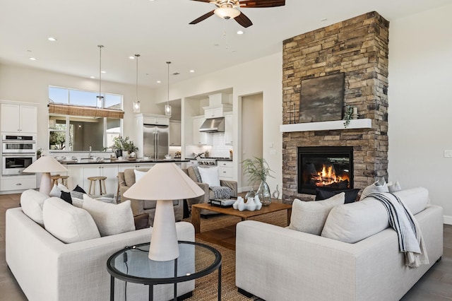 998 Highland Rd W, Madera, CA 93636 - living room with ceiling fan, a stone fireplace, recessed lighting, and dark wood-style floors