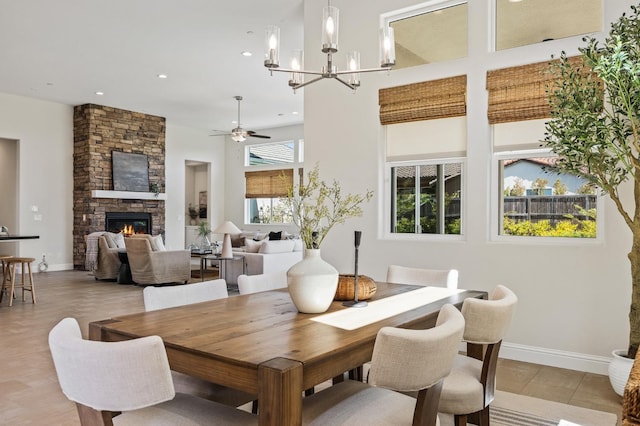 998 Highland Rd W, Madera, CA 93636 - dining space with a stone fireplace, a chandelier, recessed lighting, a towering ceiling, and a ceiling fan