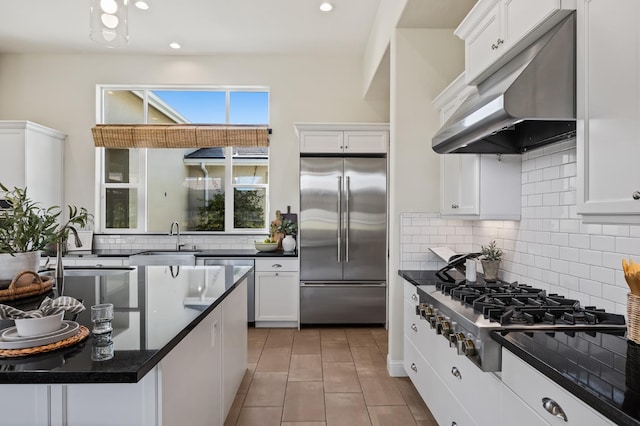 998 Highland Rd W, Madera, CA 93636 - kitchen featuring appliances with stainless steel finishes, under cabinet range hood, dark countertops, white cabinets, and recessed lighting