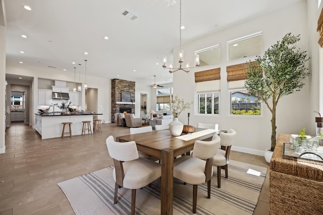 998 Highland Rd W, Madera, CA 93636 - dining room featuring a fireplace, recessed lighting, a chandelier, and ceiling fan