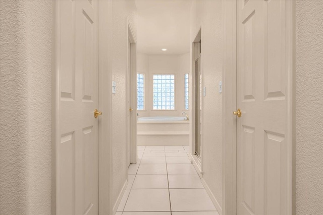 431 S Fowler Ave, Fresno, CA 93727 - corridor with a textured wall and light tile patterned flooring