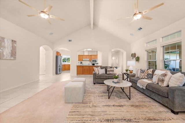 431 S Fowler Ave, Fresno, CA 93727 - living room featuring a ceiling fan, light tile patterned floors, arched walkways, high vaulted ceiling, and beam ceiling