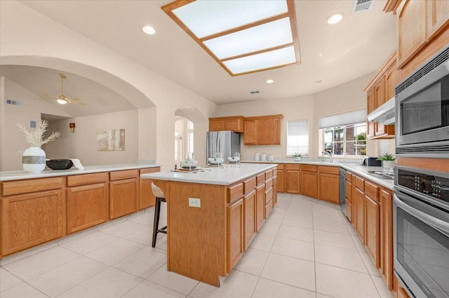 431 S Fowler Ave, Fresno, CA 93727 - kitchen with appliances with stainless steel finishes, a center island, light countertops, a breakfast bar, and recessed lighting