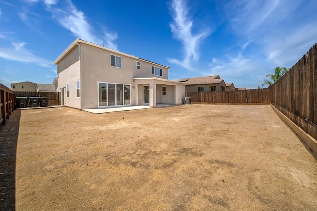 503 Cathedral Ct S, Madera, CA 93636 - back of house with stucco siding, a patio area, and a fenced backyard