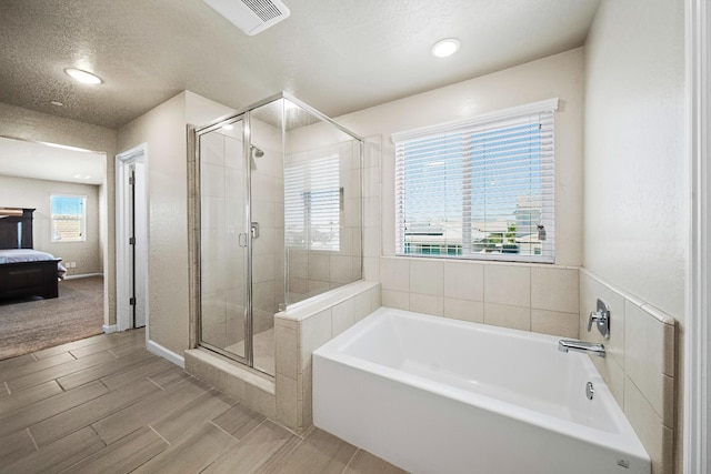503 Cathedral Ct S, Madera, CA 93636 - bathroom with a garden tub, a stall shower, wood finished floors, and recessed lighting