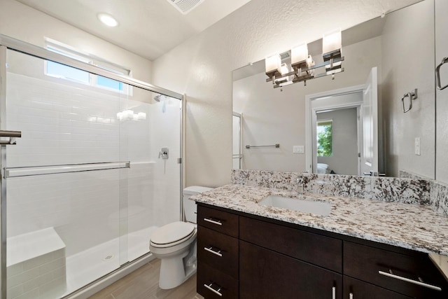 503 Cathedral Ct S, Madera, CA 93636 - full bathroom featuring plenty of natural light, a shower stall, vanity, and wood finished floors