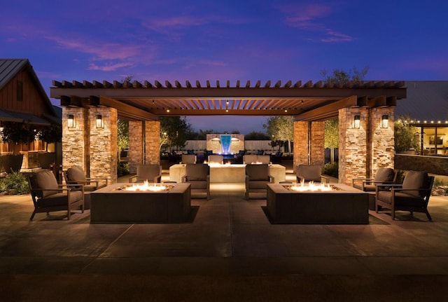 503 Cathedral Ct S, Madera, CA 93636 - patio terrace at dusk featuring a patio, a pergola, and an outdoor living space with a fire pit