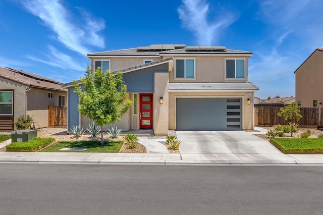 503 Cathedral Ct S, Madera, CA 93636 - view of front of house with a garage, stucco siding, roof mounted solar panels, and driveway