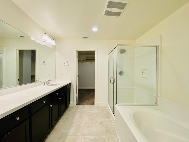 578 S Alpine Way S, Madera, CA 93636 - bathroom featuring a walk in closet, a stall shower, vanity, a garden tub, and tile patterned floors