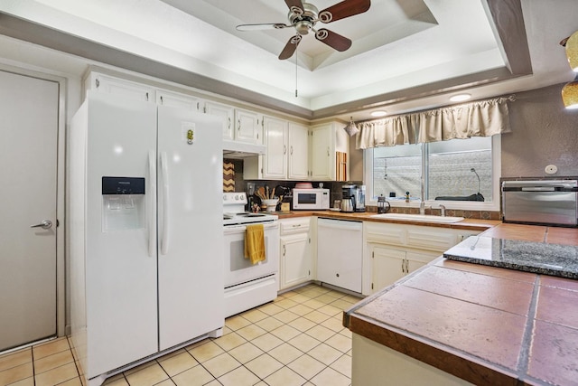11736 Waverly Rd, Madera, CA 93636 - kitchen featuring white appliances, a tray ceiling, a ceiling fan, light tile patterned floors, and white cabinetry
