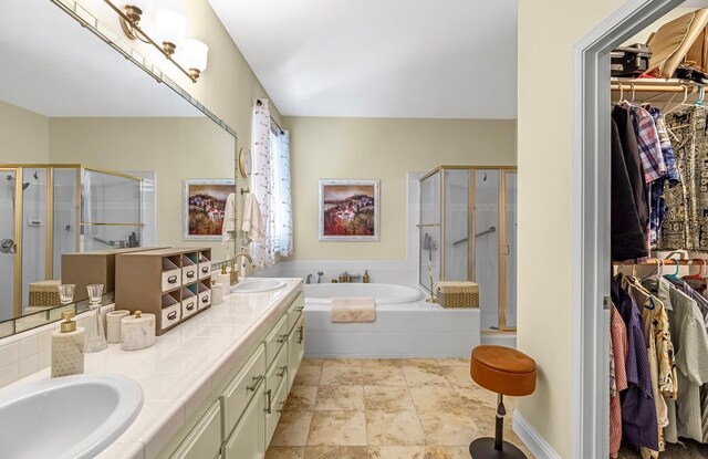 4632 W Minarets Ave, Fresno, CA 93722 - full bath featuring a shower stall, a bath, double vanity, and a walk in closet