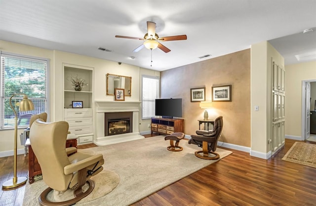 4632 W Minarets Ave, Fresno, CA 93722 - living room featuring ceiling fan, wood finished floors, plenty of natural light, and a glass covered fireplace