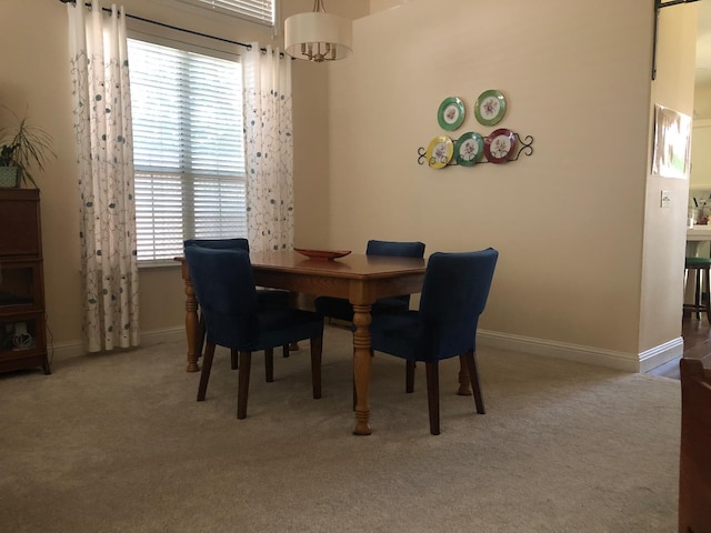 4632 W Minarets Ave, Fresno, CA 93722 - carpeted dining space featuring baseboards and a chandelier