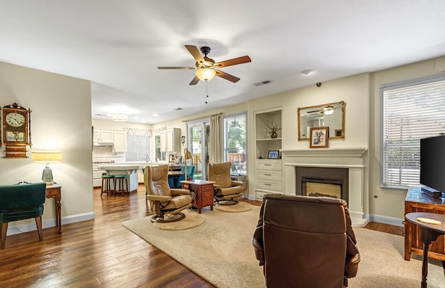 4632 W Minarets Ave, Fresno, CA 93722 - living room with a ceiling fan, wood finished floors, and a fireplace