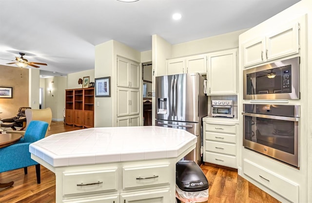 4632 W Minarets Ave, Fresno, CA 93722 - kitchen with stainless steel appliances, tile countertops, a ceiling fan, dark wood finished floors, and recessed lighting