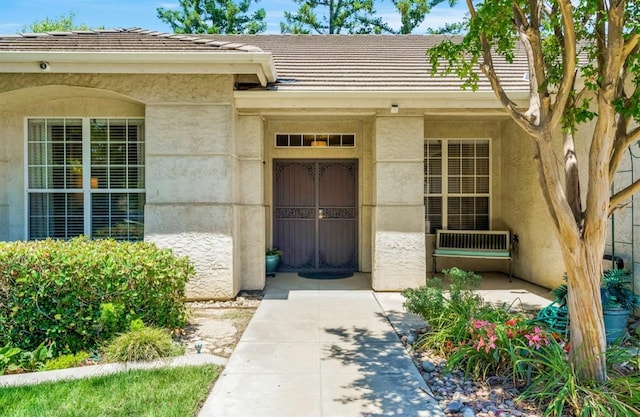 4632 W Minarets Ave, Fresno, CA 93722 - view of exterior entry featuring a tile roof and stucco siding