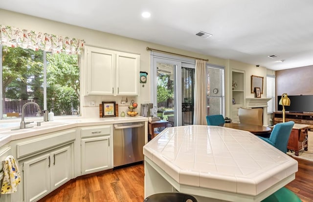 4632 W Minarets Ave, Fresno, CA 93722 - kitchen with dishwasher, tile countertops, wood finished floors, recessed lighting, and white cabinets