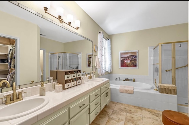 4632 W Minarets Ave, Fresno, CA 93722 - bathroom featuring a shower stall, a garden tub, double vanity, and a walk in closet