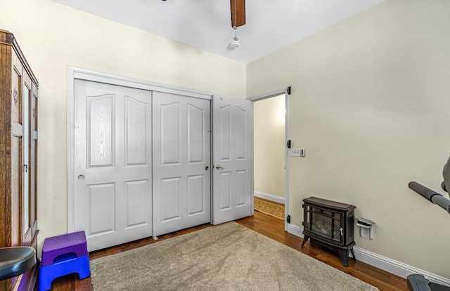 4632 W Minarets Ave, Fresno, CA 93722 - sitting room featuring a wood stove, wood finished floors, and a ceiling fan