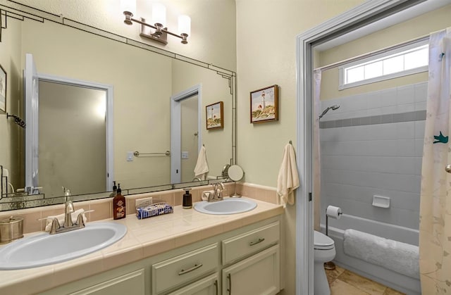 4632 W Minarets Ave, Fresno, CA 93722 - bathroom with double vanity, shower / tub combo with curtain, and tile patterned floors