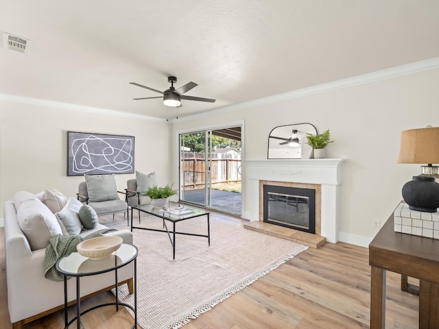 3844 E Holland Ave, Fresno, CA 93726 - living area with ceiling fan, crown molding, a tile fireplace, and light wood finished floors