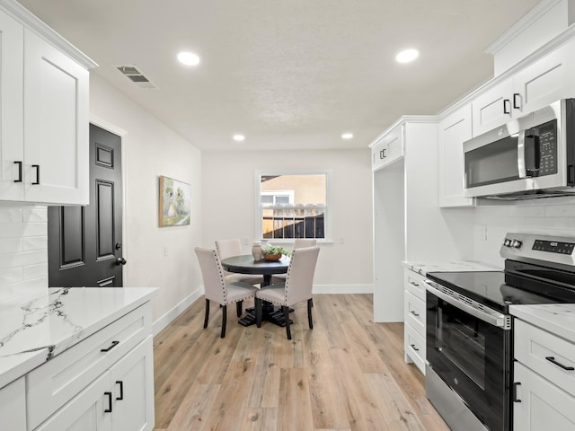 3844 E Holland Ave, Fresno, CA 93726 - kitchen featuring stainless steel appliances, recessed lighting, backsplash, and white cabinets