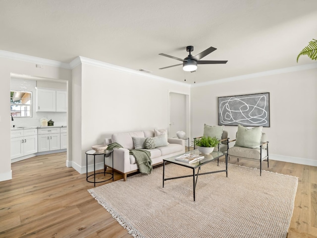 3844 E Holland Ave, Fresno, CA 93726 - living area featuring crown molding, light wood-type flooring, and ceiling fan