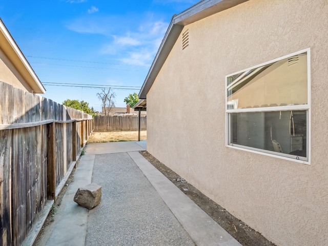 3844 E Holland Ave, Fresno, CA 93726 - view of property exterior featuring stucco siding and a patio