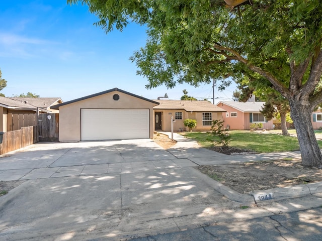 3844 E Holland Ave, Fresno, CA 93726 - ranch-style house with an attached garage, stucco siding, and concrete driveway