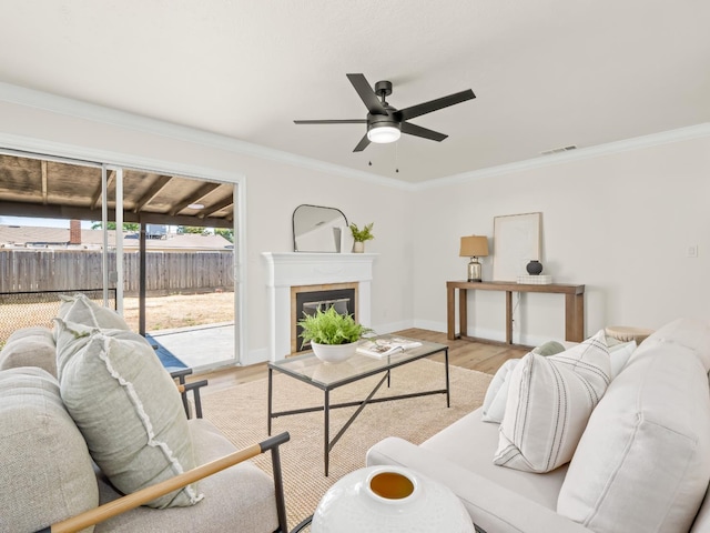 3844 E Holland Ave, Fresno, CA 93726 - living area with a ceiling fan, wood finished floors, ornamental molding, and a tile fireplace