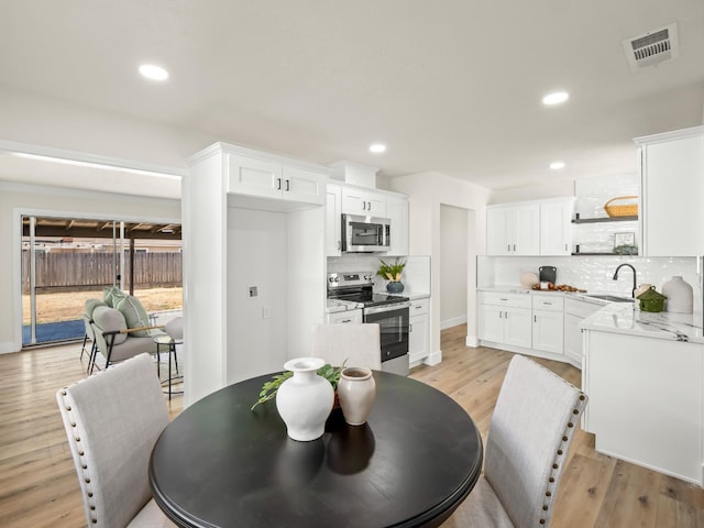 3844 E Holland Ave, Fresno, CA 93726 - dining area with light wood-style floors and recessed lighting
