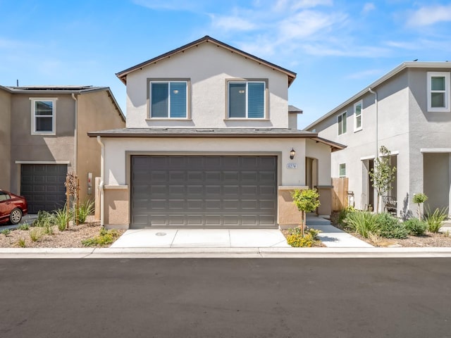 6274 E Riesling Dr, Fresno, CA 93727 - view of front of home with stucco siding, a garage, and driveway