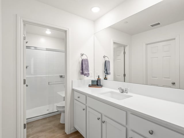 6274 E Riesling Dr, Fresno, CA 93727 - bathroom featuring vanity, a stall shower, wood finished floors, and recessed lighting