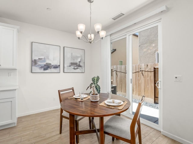 6274 E Riesling Dr, Fresno, CA 93727 - dining area with light wood-style floors and a chandelier
