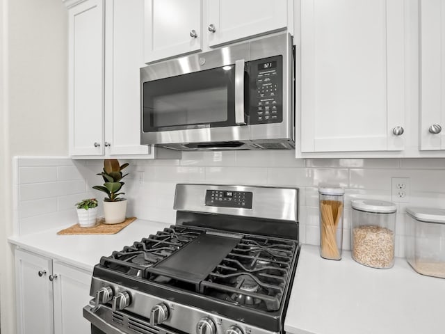 6274 E Riesling Dr, Fresno, CA 93727 - kitchen with stainless steel appliances, light countertops, white cabinets, and backsplash