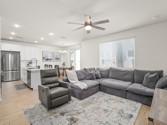 6274 E Riesling Dr, Fresno, CA 93727 - living room featuring a ceiling fan, light wood finished floors, a chandelier, and recessed lighting