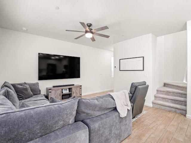 6274 E Riesling Dr, Fresno, CA 93727 - living room featuring ceiling fan, light wood finished floors, and stairs