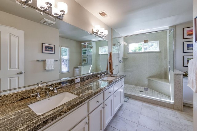 3084 Magnolia Ave, Clovis, CA 93611 - full bath with a chandelier, a stall shower, double vanity, and tile patterned flooring