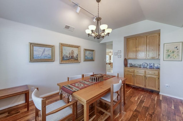 3084 Magnolia Ave, Clovis, CA 93611 - dining space featuring a chandelier, lofted ceiling, dark wood finished floors, and track lighting