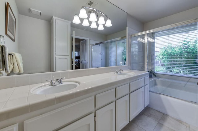 3084 Magnolia Ave, Clovis, CA 93611 - bathroom featuring double vanity, a garden tub, tile patterned flooring, a shower stall, and a chandelier