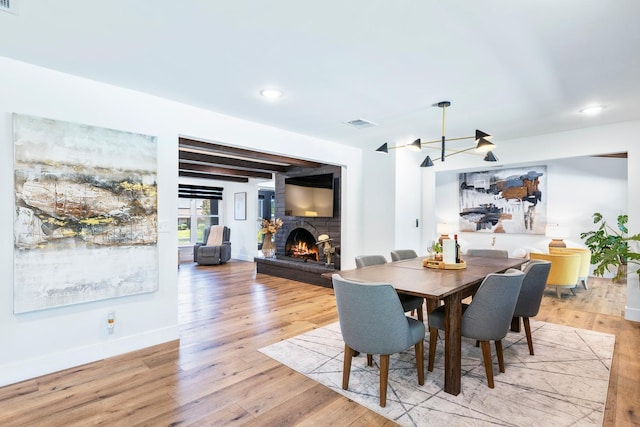 6054 N Kavanagh Ave, Fresno, CA 93711 - dining area with a fireplace, light wood-style floors, beam ceiling, and recessed lighting