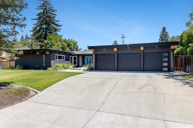 6054 N Kavanagh Ave, Fresno, CA 93711 - modern home with stucco siding, driveway, and an attached garage
