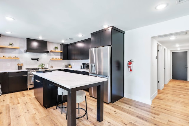 6054 N Kavanagh Ave, Fresno, CA 93711 - kitchen featuring appliances with stainless steel finishes, custom exhaust hood, open shelves, dark cabinets, and a breakfast bar