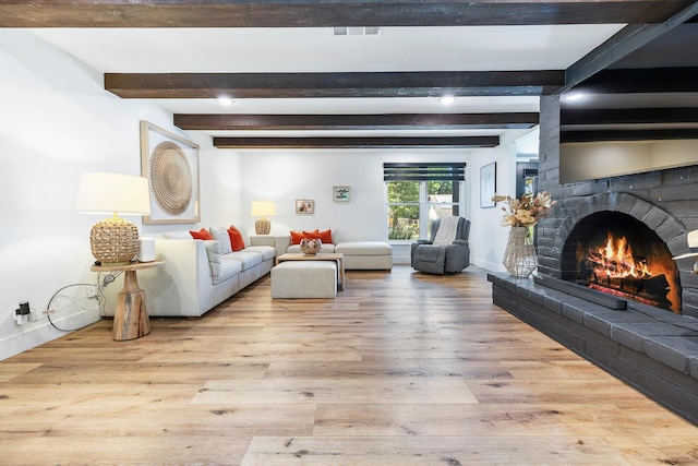 6054 N Kavanagh Ave, Fresno, CA 93711 - living area with a warm lit fireplace, beam ceiling, and wood finished floors