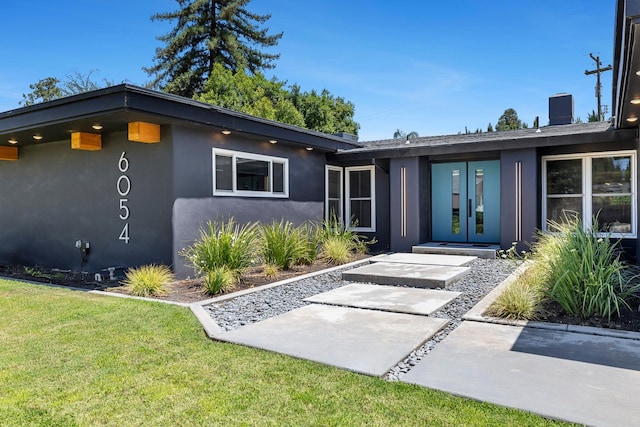 6054 N Kavanagh Ave, Fresno, CA 93711 - view of front facade featuring stucco siding and a front lawn